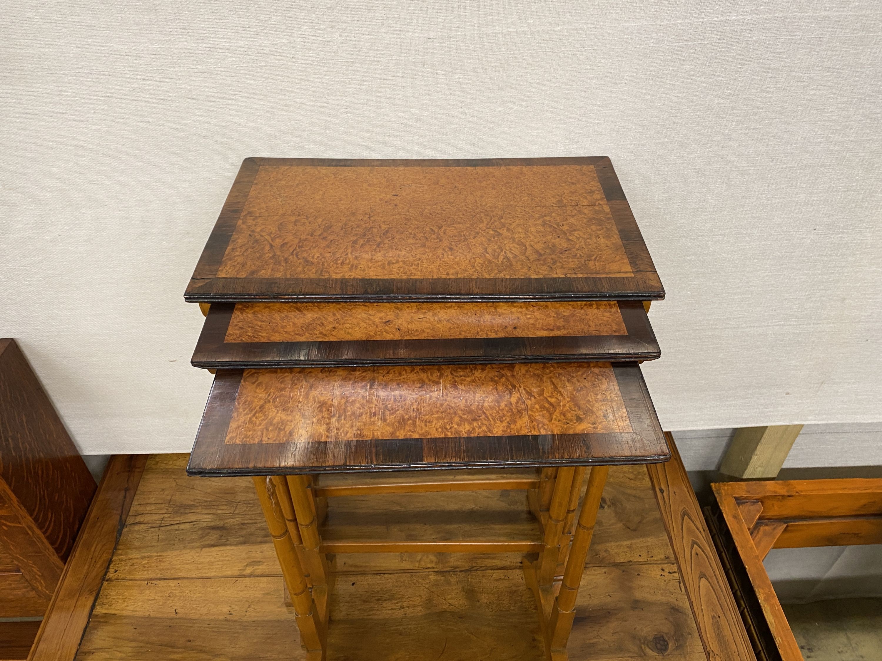 A nest of three mahogany and bird's eye maple rectangular tea tables, width 50cm, depth 30cm, height 69cm